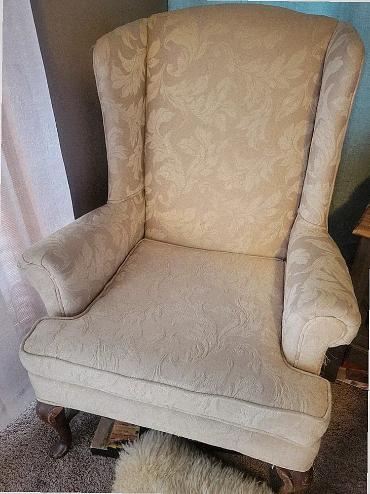 cream-colored Queen Anne-style armchair